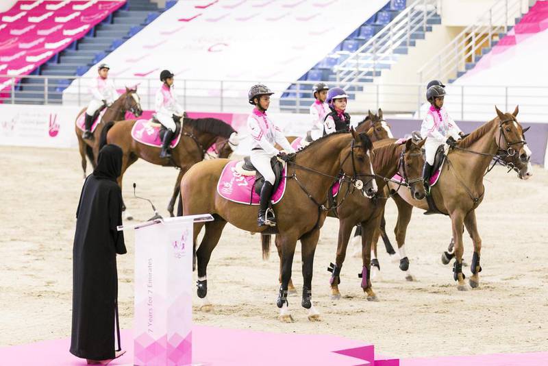 Young riders, each representing an emirate, receive ribbons at the launch of the Pink Caravan. Reem Mohammed / The National