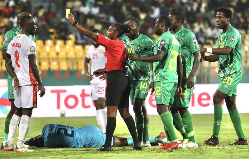 Referee Salima Mukansanga shows a yellow card to Guinea captain Naby Keita. EPA