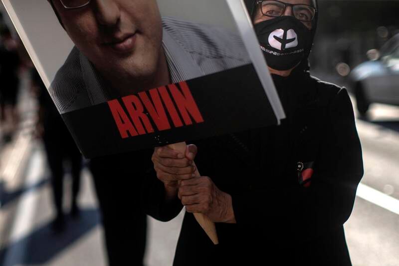 A placard bearing the face of a victim of Flight PS752 is carried in Toronto. The Canadian Press via AP