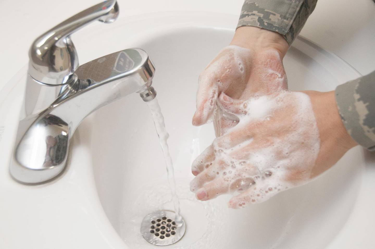 An Airman washes her hands with soap and water at Wilford Hall Ambulatory Surgical Center, Joint Base San Antonio Lackland, Texas Dec. 13, 2012. Hand washing is one of the most effective ways to prevent the spread of many types of infection and illness in all environments. (U.S. Air Force photo/Staff Sgt. Corey Hook)
