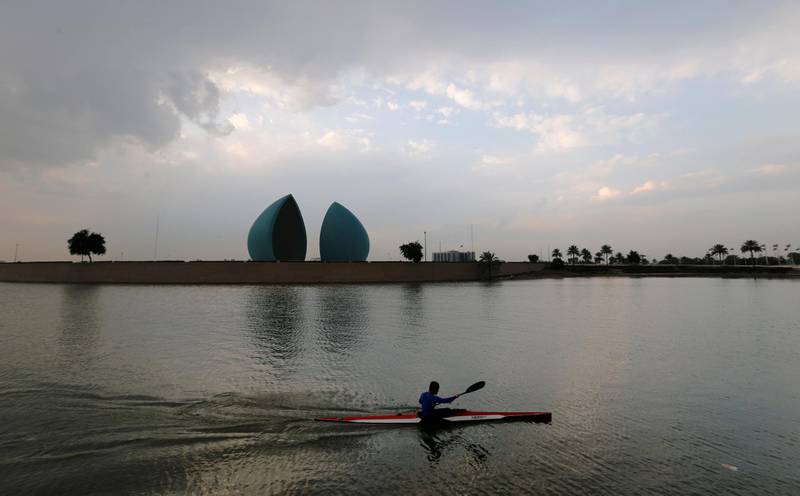 A man paddles past the Martyr's Memorial in Baghdad, Iraq. Reuters