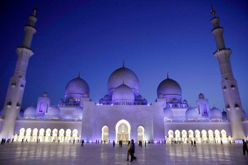 ABU DHABI, UNITED ARAB EMIRATES - August 22, 2009: Muslims make their way to evening prayer at Sheikh Zayed Grand Mosque after breaking fast at Iftar on the first day of Ramadan. ( Ryan Carter / The National )