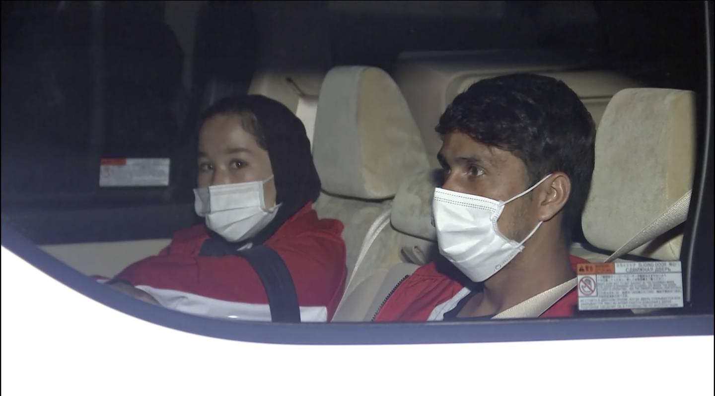 Afghan athletes Zakia Khudadadi, left, and Hossain Rasouli arrive at Haneda airport in Tokyo after a harrowing journey from Kabul to Paris, to compete in the Paralympics.  AP