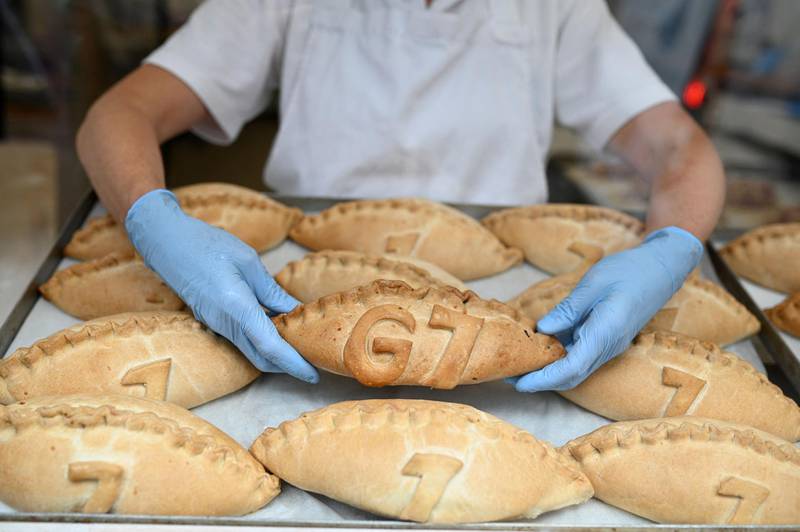 Freshly baked G7 Cornish pasties are placed in the window of a pastry shop in St Ives. AFP