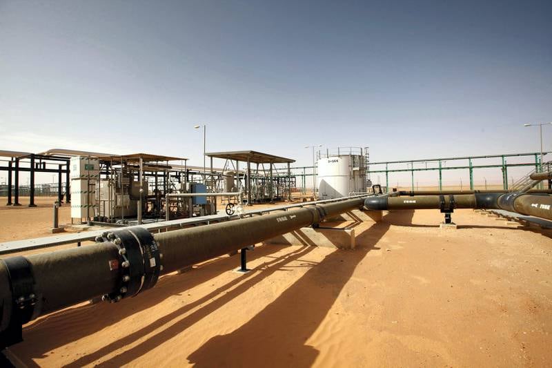 Pipes are pictured at the El Sharara oilfield December 3, 2014. Deep in Libya's southern Sahara, men in army uniforms guard a pipeline at the El Sharara oilfield. Hundreds of kilometers to the north, rival fighters turn off the pumps to stop the oil flowing. The standoff over El Sharara illustrates the complex challenge United Nations mediators face in holding together a country heading towards a civil war between factions allied with rival cities scrambling for control. U.N. envoys plan to bring the Libyan rivals together on Tuesday for a dialog, but the conflict is spreading with both sides increasingly at odds over the OPEC country's vast oil resources. Picture taken December 3, 2014. REUTERS/Ismail Zitouny (LIBYA - Tags: POLITICS CIVIL UNREST ENERGY)