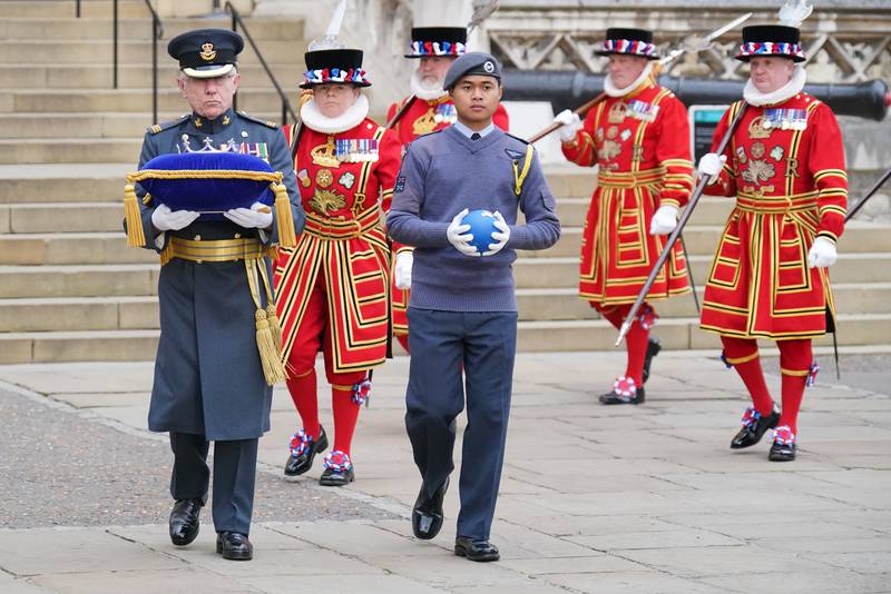 A member of the Royal Air Force Air Cadets holding the Commonwealth of Nations' Globe on its arrival at the Tower of London. It will be on display until June 2, when it will be used to light Buckingham Palace's principal beacon. PA