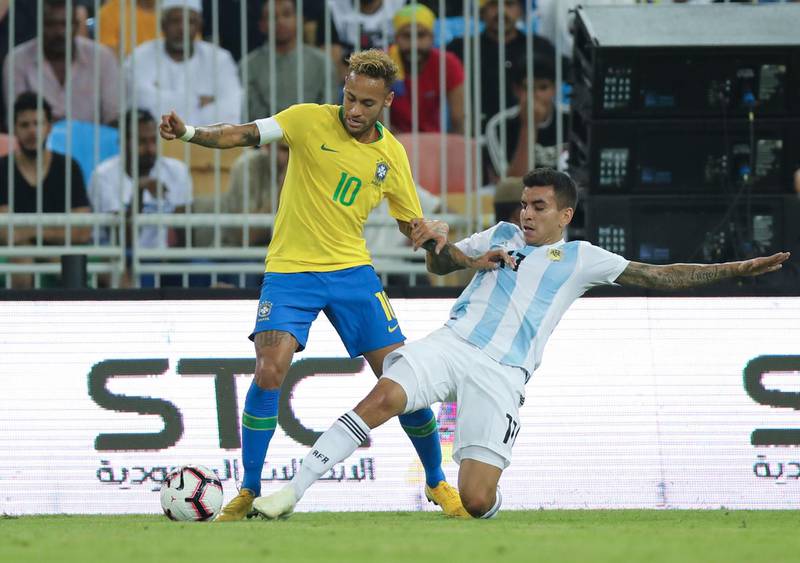 Brazil forward Neymar, left, and Argentina's Angel Correa compete for the ball during a friendly at King Abdullah Stadium. AP Photo