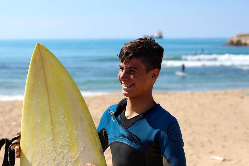 ‘Little Ali’ now works at Mr Elamine’s surf shop and school, and gets to use all the equipment there and surfs as much as he wants. Josh Wood for The National