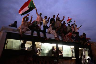 Flags are waved as people celebrate after the signature of the power sharing agreement. EPA/MORWAN ALI