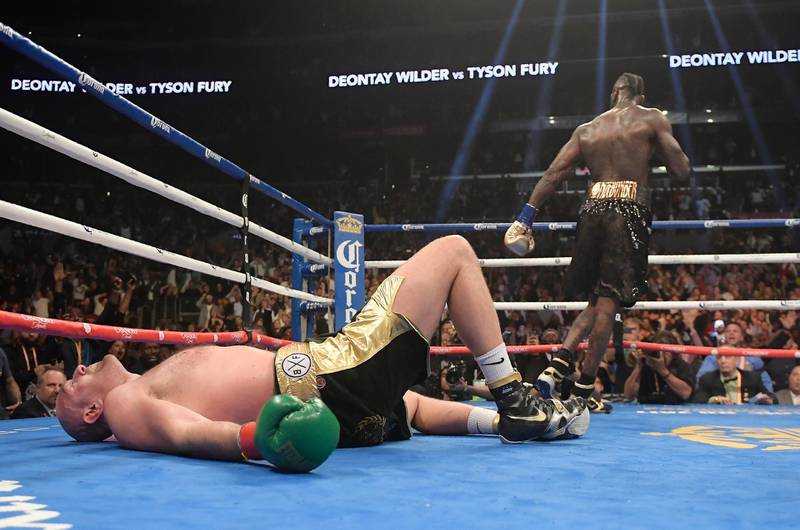 Tyson Fury lies on the canvas after being knocked down by Deontay Wilder during the 12th round. AP Photo
