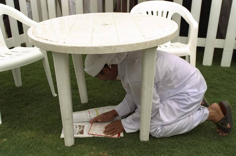 A man studies form in the rain at the second Dubai World Cup at the Nad Al Sheba racecourse in 1997. Julian Herbert / Allsport