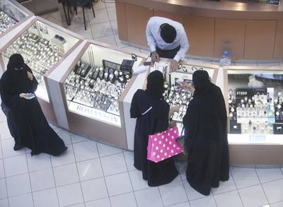 Female shoppers wearing traditional Saudi Arabian dress browse watches on sale at a luxury concession stand inside the Kingdom Centre shopping mall in Riyadh, Saudi Arabia, on Friday, Dec. 2, 2016. Saudi Arabia is working to reduce the Middle East’s biggest economy’s reliance on oil, which provides three-quarters of government revenue, as part of a plan for the biggest economic shakeup since the country’s founding. Photographer: Simon Dawson/Bloomberg