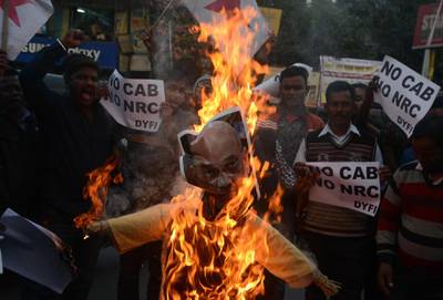 Left-wing activists of the Democratic Youth Federation of India shout slogans as they burn an effigy of India's Home Minister Amit Shah during a demonstration against the government's Citizenship Amendment Bill in Siliguri.  AFP