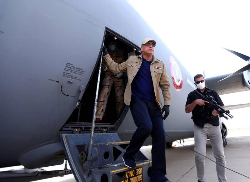 A handout picture released by Iraq's Prime Minister's Media Office on June 2, 2020 shows Iraqi Prime Minister Mustafa Kadhimi (L) arriving in Kirkuk, for an official visit, one month after Islamic State group jihadists claimed a suicide attack that wounded four people outside an intelligence headquarters in the multi-ethnic city. (Photo by - / IRAQI PRIME MINISTER'S PRESS OFFICE / AFP) / === RESTRICTED TO EDITORIAL USE - MANDATORY CREDIT "AFP PHOTO / HO / IRAQI PRIME MINISTER'S PRESS OFFICE" - NO MARKETING NO ADVERTISING CAMPAIGNS - DISTRIBUTED AS A SERVICE TO CLIENTS ===