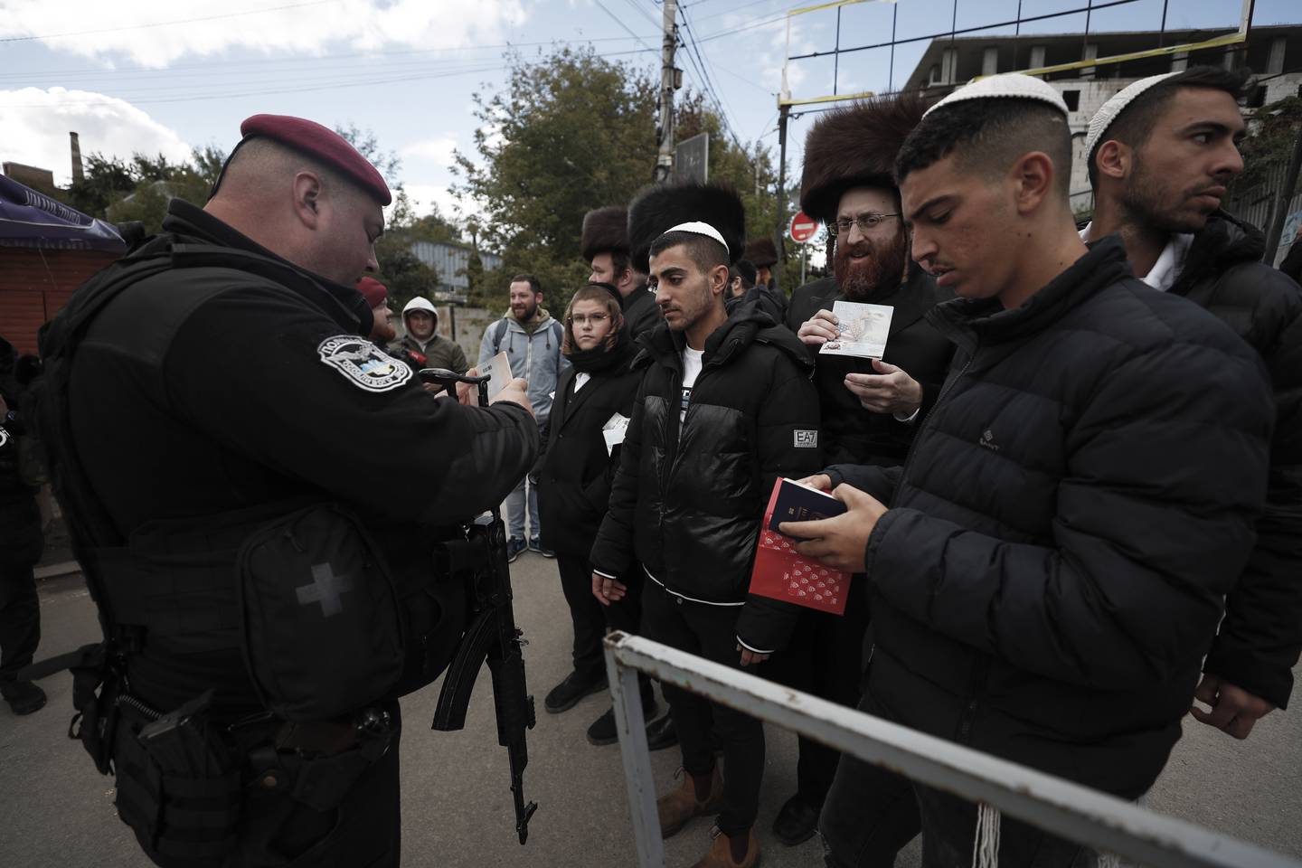 Orthodox Jews show IDs and passports to Ukrainian security guards. EPA