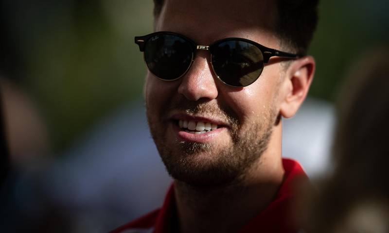Ferrari's Sebastian Vettel smiles as he talks to the media. Getty