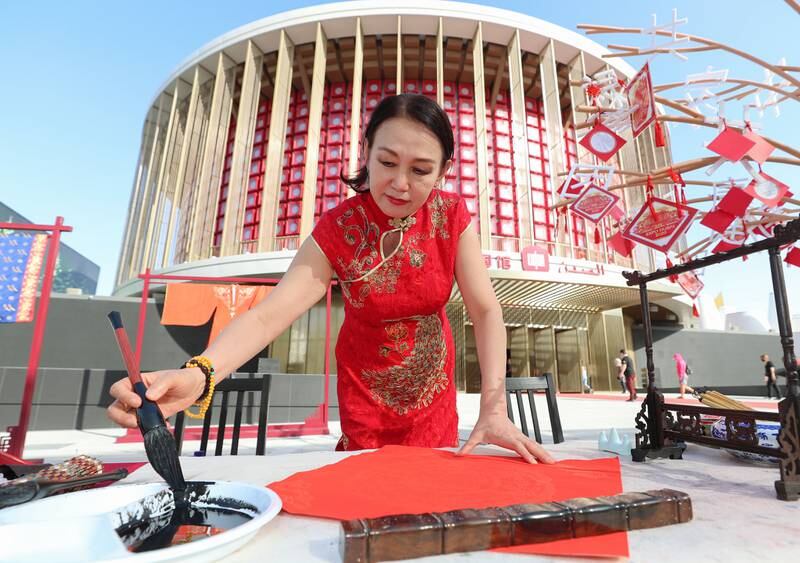 Chinese calligraphy artist Li Dongxia during Expo 2020 Dubai. Chris Whiteoak / The National