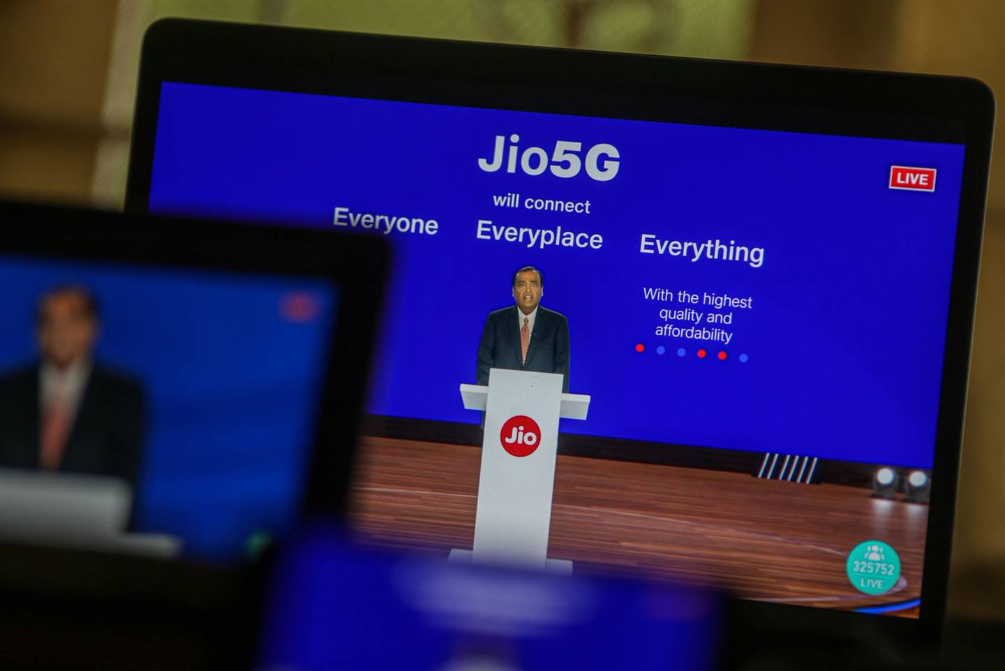 Mukesh Ambani, chairman and managing director of Reliance Industries, speaks via live stream during the company's annual general meeting last month in Mumbai. Bloomberg