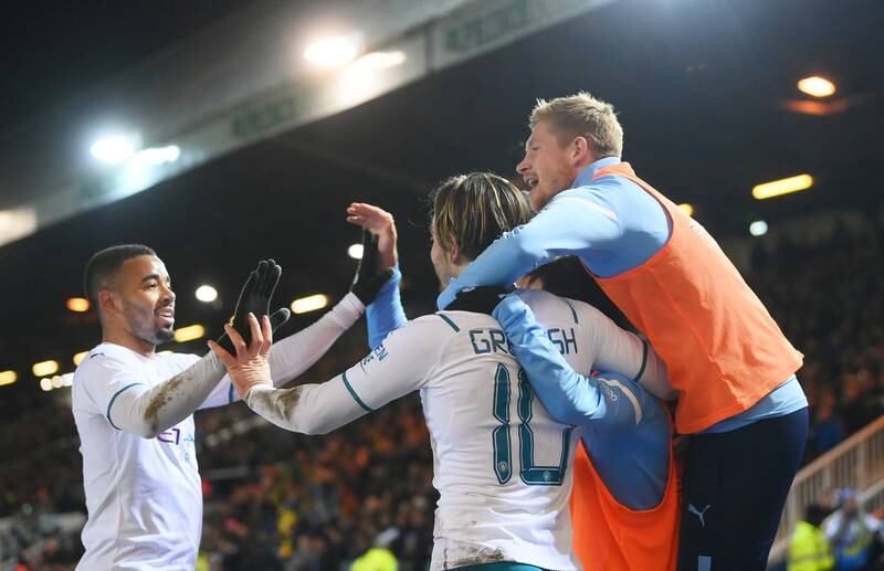 Grealish celebrates with teammates Gabriel Jesus and Kevin De Bruyne. Getty