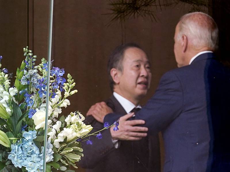 US President Joe Biden is embraced by Japan's ambassador to the US Tomita Koji on Saturday, a day after Japan's former prime minister Shinzo Abe was fatally shot. Reuters