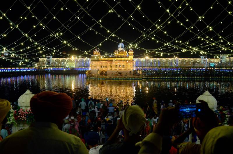 Indian Sikh devotees pay their respects on the eve of the birth anniversary of the fourth Sikh Guru Ramdas at the illuminated Golden Temple in Amritsar.  AFP