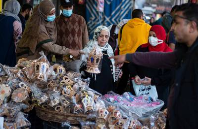 Families buy fanous decorations at a market in Cairo. EPA