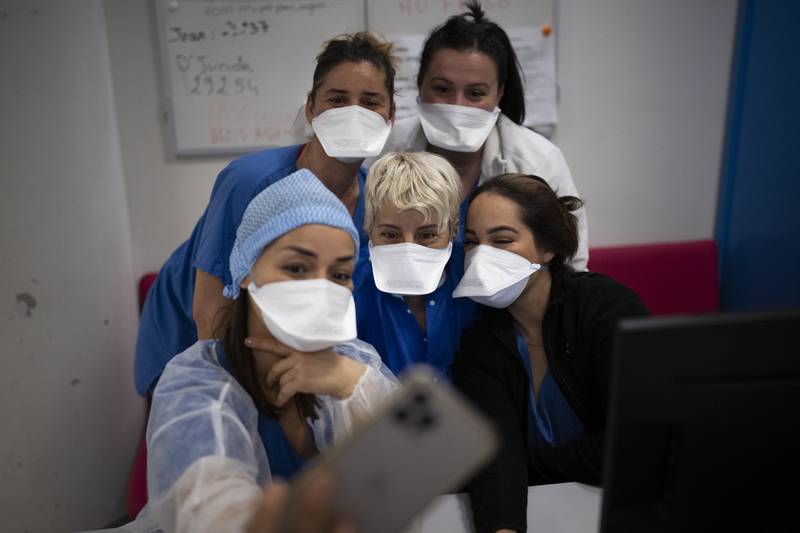 Hospital workers gather for a selfie in the Covid-19 intensive care unit of the La Timone hospital in Marseille, southern France. One of the country’s largest hospitals, La Timone has weathered wave after wave of coronavirus. AP