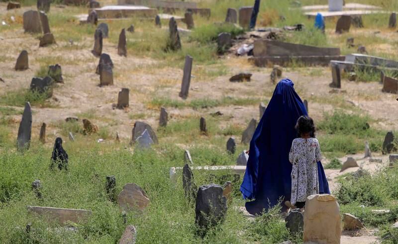An Afghan woman walks in a graveyard in Kabul. EPA