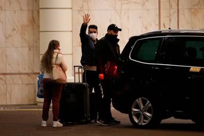 Travellers leave the Radisson Blu hotel after completing their quarantine period. Getty Images