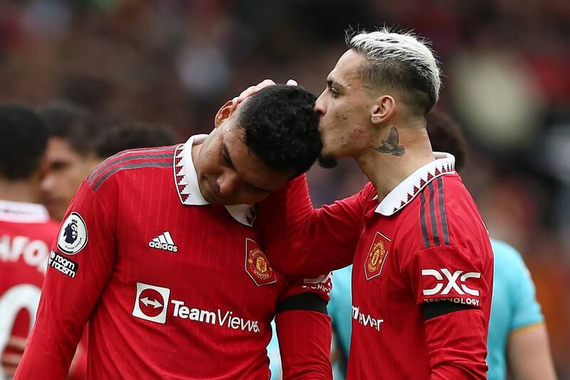 Manchester United's Casemiro is consoled by teammate Antony after receiving a red card against Southampton. EPA