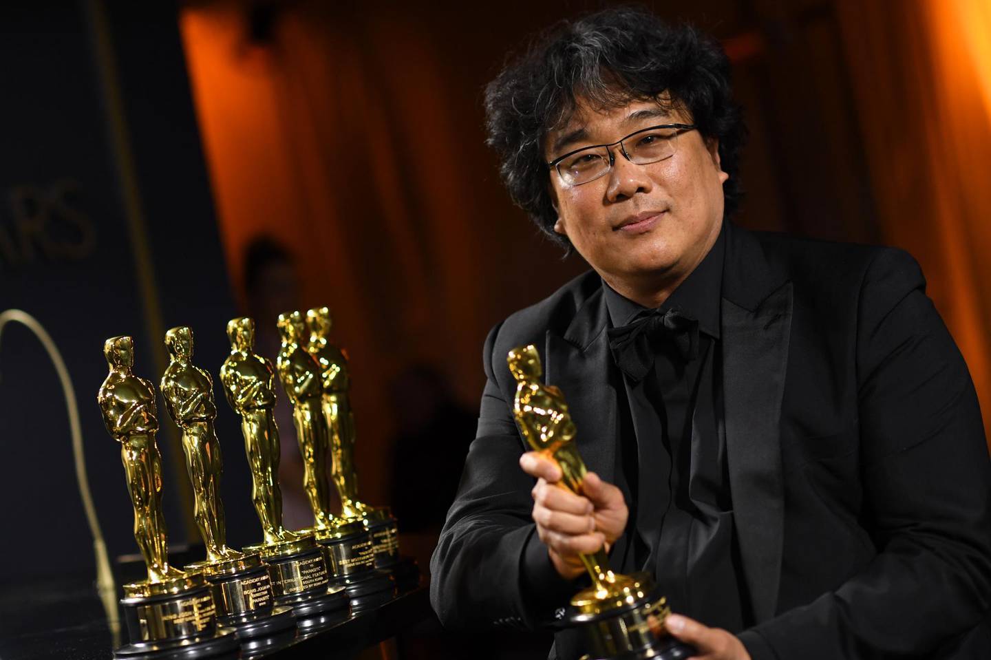 (FILES) In this file photo taken on February 10, 2020 South Korean film director Bong Joon Ho poses with his engraved awards as he attends the 92nd Oscars Governors Ball at the Hollywood & Highland Center in Hollywood, California. Palme d'Or and Oscar academy awards winner, South Korean director Bong Joon-ho will preside over the jury of the 78th edition of the Venice Film Festival, which will take place from through September 1-11, 2021 organisers announced on January 15, 2021. / AFP / VALERIE MACON
