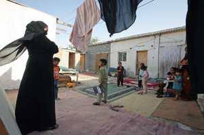 DUBAI, UNITED ARAB EMIRATES - MARCH 19:  Women and their children who live on the same compound and who cannot afford to send their kids to school, pictured at their home in Dubai on March 19, 2010. (Randi Sokoloff / The National)  For News story by Anealla Safdar  EDITORS NOTE: We were told not to identify the women, either by showing their faces or by printing their names. The kids are okay to be identified in the photos as is one woman (in orange, R) who said she did not mind. Also, I was asked not to release the location of the compound or the name of the co-ordinator