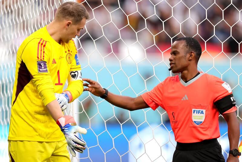 Assistant referee Zachari Zeegelaar checks the captain's armband of German goalkeeper Manuel Neuer before the group E tussle with Japan. EPA