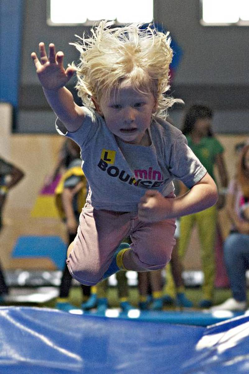 A toddler jumps from a trampoline and dives into an inflated landing mattress at Bounce. Jeff Topping for The National