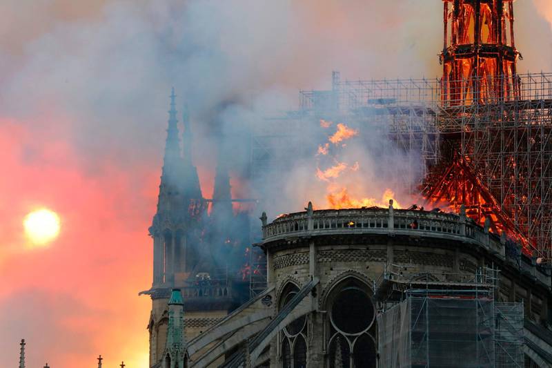 Smoke billows as flames destroy the roof of the landmark Notre-Dame Cathedral in central Paris on April 15, 2019. AFP