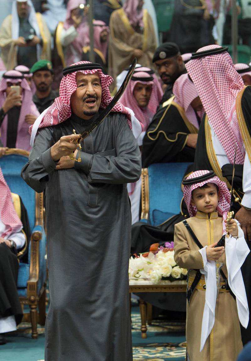 King Salman of Saudi Arabia performs the traditional Ardah sword dance as part of the activities of the Janadriyah cultural festival in Riyadh on February 20, 2018. Bandar Algaloud / Courtesy of Saudi Royal Court / Reuters