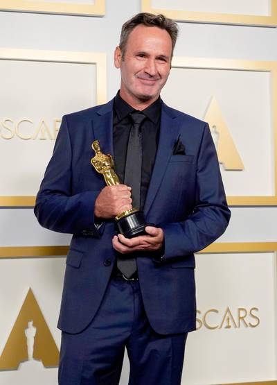 Best Visual Effects: Scott R Fisher, for 'Tenet', poses in the press room at the Oscars on Sunday, April 25, 2021, at Union Station in Los Angeles. Reuters