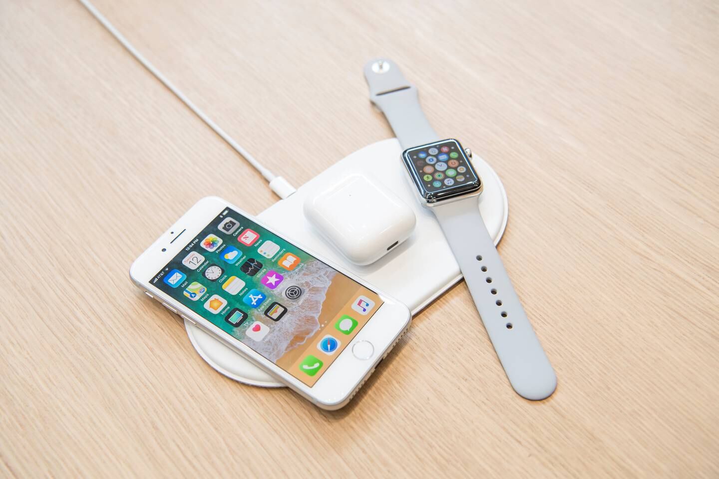 The Apple Inc. iPhone 8, Airpods, and Apple Watch sit on the AirPower charger during an event at the Steve Jobs Theater in Cupertino, California, U.S., on Tuesday, Sept. 12, 2017. Apple Inc. unveiled its most important new iPhone for years to take on growing competition from Samsung Electronics Co., Google and a host of Chinese smartphone makers. The device, coming a decade after the original model, is Apple's first major redesign since 2014 and represents a significant upgrade to the iPhone 7 line. Photographer: David Paul Morris/Bloomberg