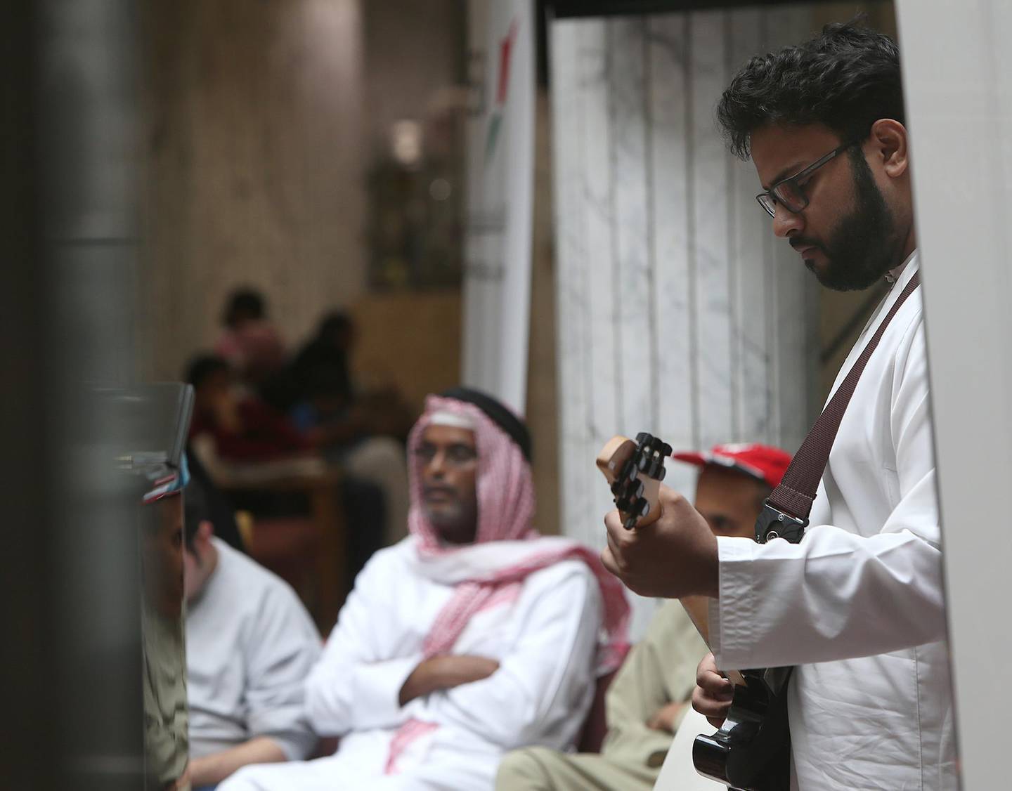 ABU DHABI - UNITED ARAB EMIRATES - 04APRIL2016 - Mohammed Al Awadi on gitar performing Music In Hospitals for patients, its the first event in Abu Dhabi Festival's month-long community & education programme held at Sheikh Khalifa Medical City (SKMC) yesterday in Abu Dhabi. Ravindranath K / The National (for News)
ID: 93523
 *** Local Caption ***  RK0404-music14.jpg