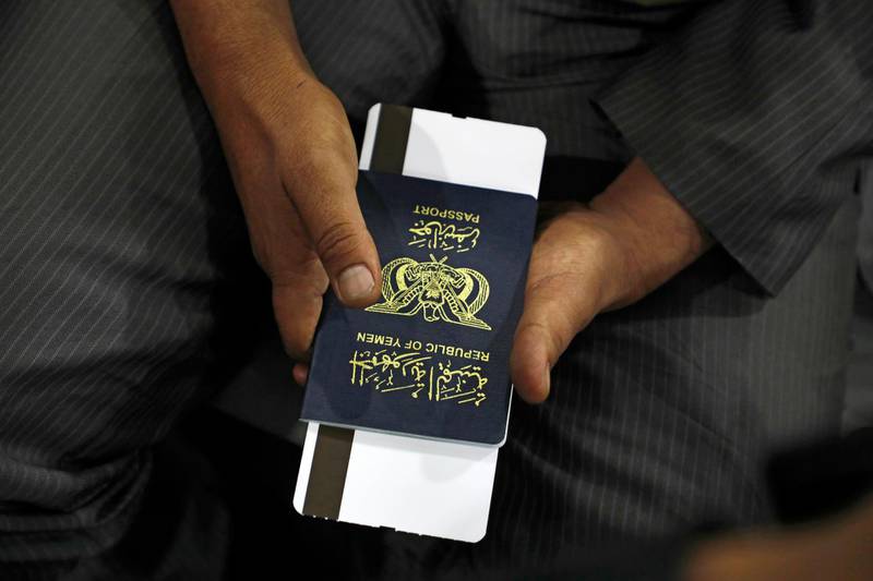 A Yemeni man holds his passport as he waits in departure lounge at Sanaa International airport, Yemen. AP Photo