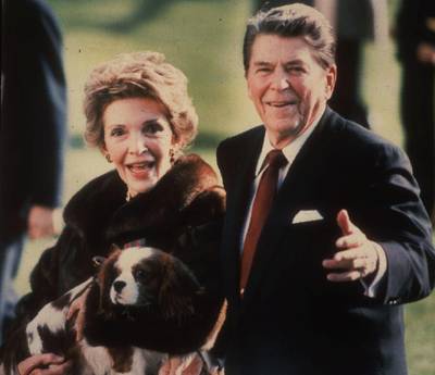 Mandatory Credit: Photo by Dennis Cook/AP/Shutterstock (11087592a)First lady Nancy Reagan holding the Reagans' pet Rex, a King Charles spaniel, as she and President Reagan walk on the White House South lawn. The arrival of the Biden pets will also mark the next chapter in a long history of pets residing at the White House after a four-year hiatus during the Trump administration. "Pets have always played an important role in the White House throughout the decades," said Jennifer Pickens, an author who studies White House traditionsWhite House Pets, Washington, United States - 01 Dec 1986