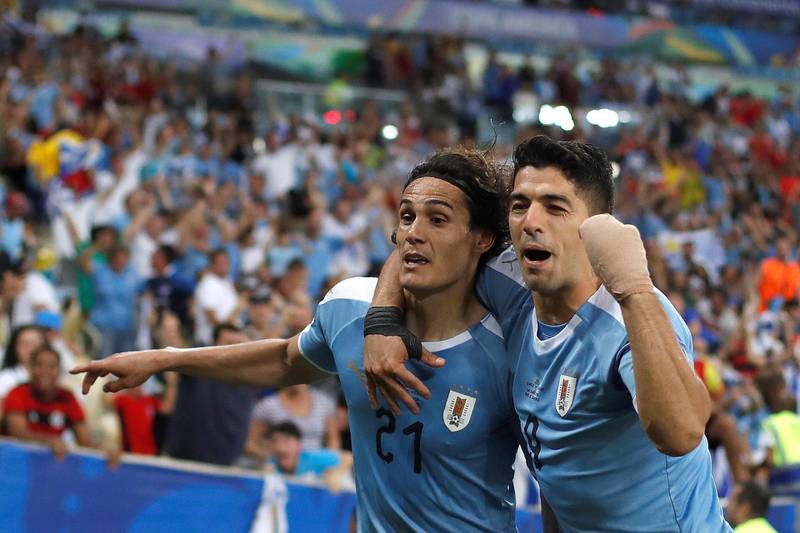 Edinson Cavani, left, of Uruguay celebrates a goal with teammate Luis Suarez against Chile at the Maracana. The 1-0 win saw Uruguay progress to the quarter-finals as Group C winners, with Chile also advancing in second place. EPA