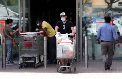 DUBAI, UNITED ARAB EMIRATES , April 05 – 2020 :- One of the shopper with protective face mask after doing shopping at the Carrefour supermarket in Ibn Battuta mall in Dubai. UAE government told residents to wear facemask and gloves all the times outside the home. (Pawan Singh / The National) For News/Online/Instagram.