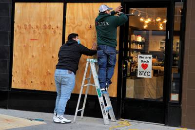 Workers board up a store ahead of election results in the Manhattan borough of New York, November 2, 2020. Reuters