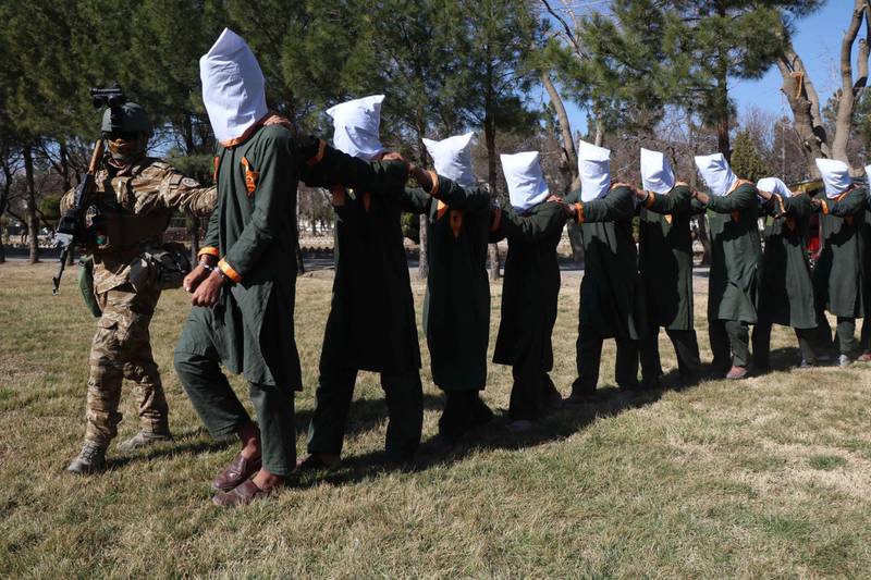 Afghan security officials present arrested members of the Taliban, in Herat, Afghanistan, on February 2, 2021. EPA
