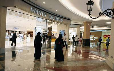DUBAI, UNITED ARAB EMIRATES - August 4:  Shoppers walk by the Harvey Nichols department store in the Mall of the Emirates in Dubai on August 4, 2008.  (Randi Sokoloff / The National)