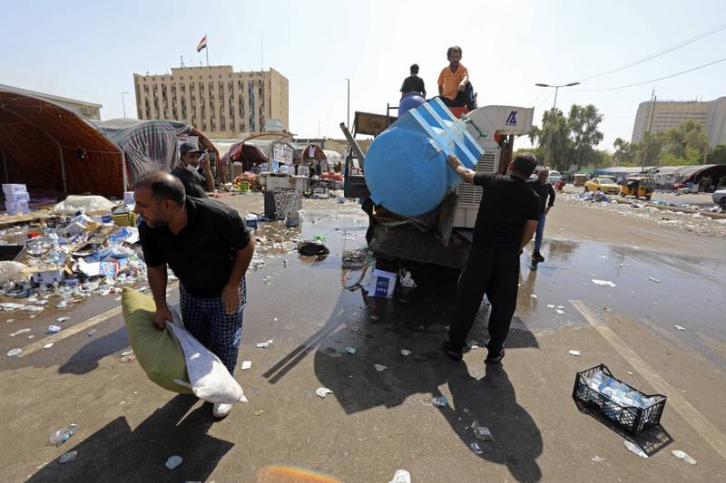 Supporters of Mr Al Sadr pack up belongings as they prepare to leave the Green Zone. AP