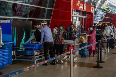 DELHI, INDIA - MAY 26: Travelers put their luggage in X-ray machine before at the drop-off point before entering Terminal 3 of the Indira Gandhi International Airport, as the country relaxed its lockdown restriction on May 26, 2020 in Delhi, India. With a slew of guidelines for passengers, India allowed commercial domestic flights to resume operations on May 25 for the first time since imposing a nationwide lockdown on March 25 to curb the spread of coronavirus, which has reportedly claimed around 4,000 lives in India so far.  (Photo by Yawar Nazir/Getty Images)