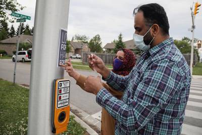 Zubair Ahmad and his wife put up a poster at the scene where pick-up  jumped the kerb and ran over a Muslim family in London, Ontario, Canada. Four people were killed in the attack. Reuters