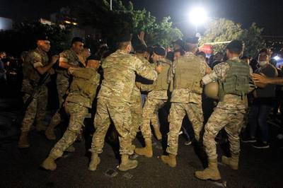 Lebanese army soldiers intervene as anti-government protesters attempt to block the main highway but with crashing currencies salaries have lost most of their value with soldiers reportedly earning the equivalent of as little as $110 a month. EPA